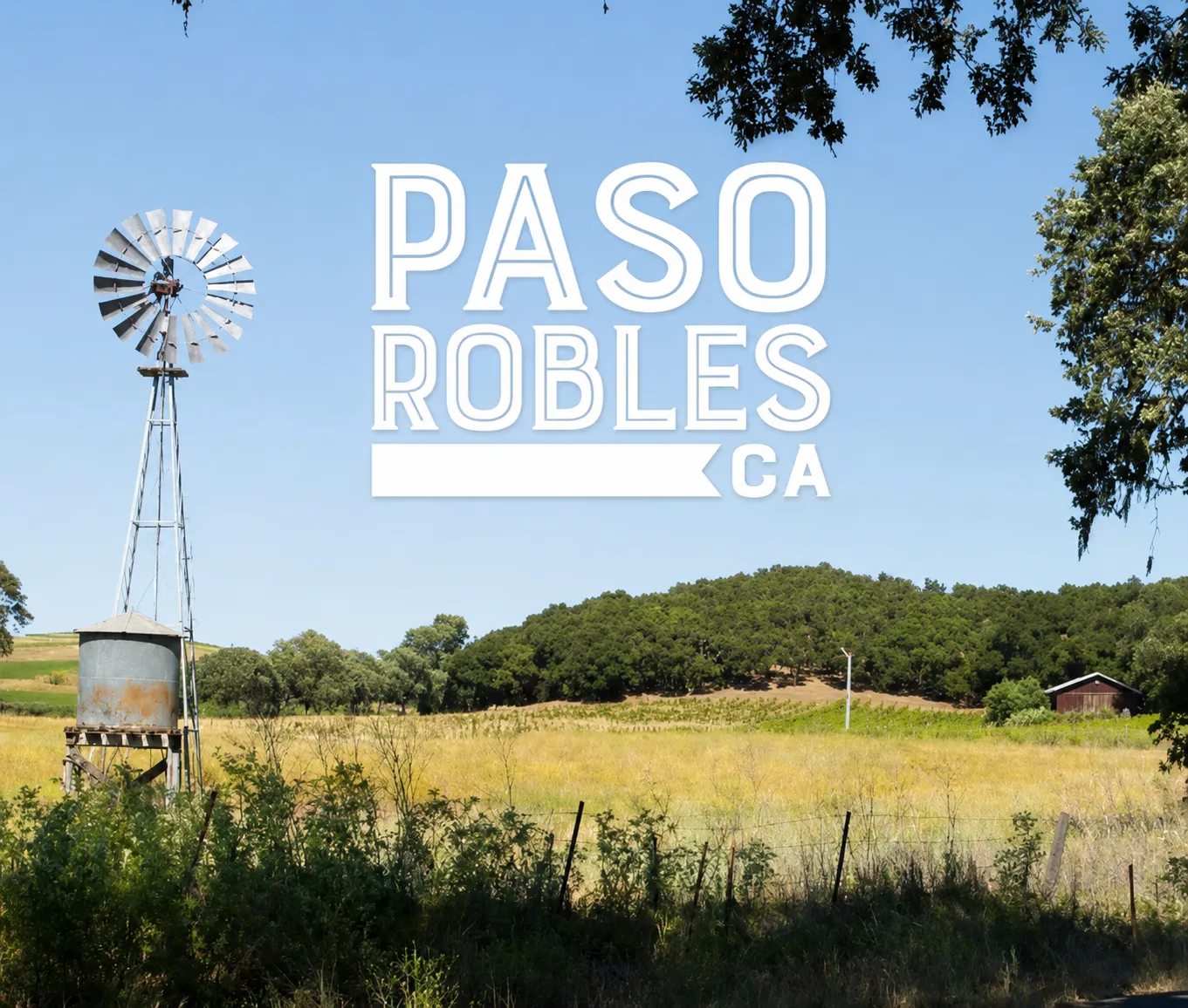 Paso Robles, California, a windmill and oak above rolling vineyard hills, with the Paso Robles wordmark